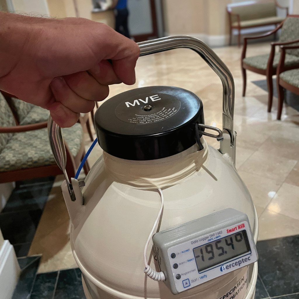 Close-up of a closed dewar being carried.