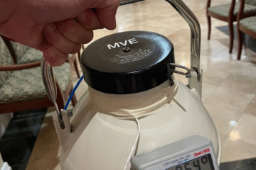 Close-up of a closed dewar being carried.