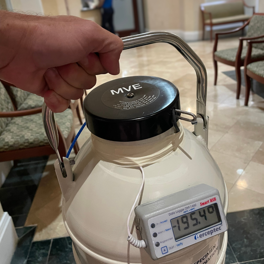 Close-up of a closed dewar being carried.