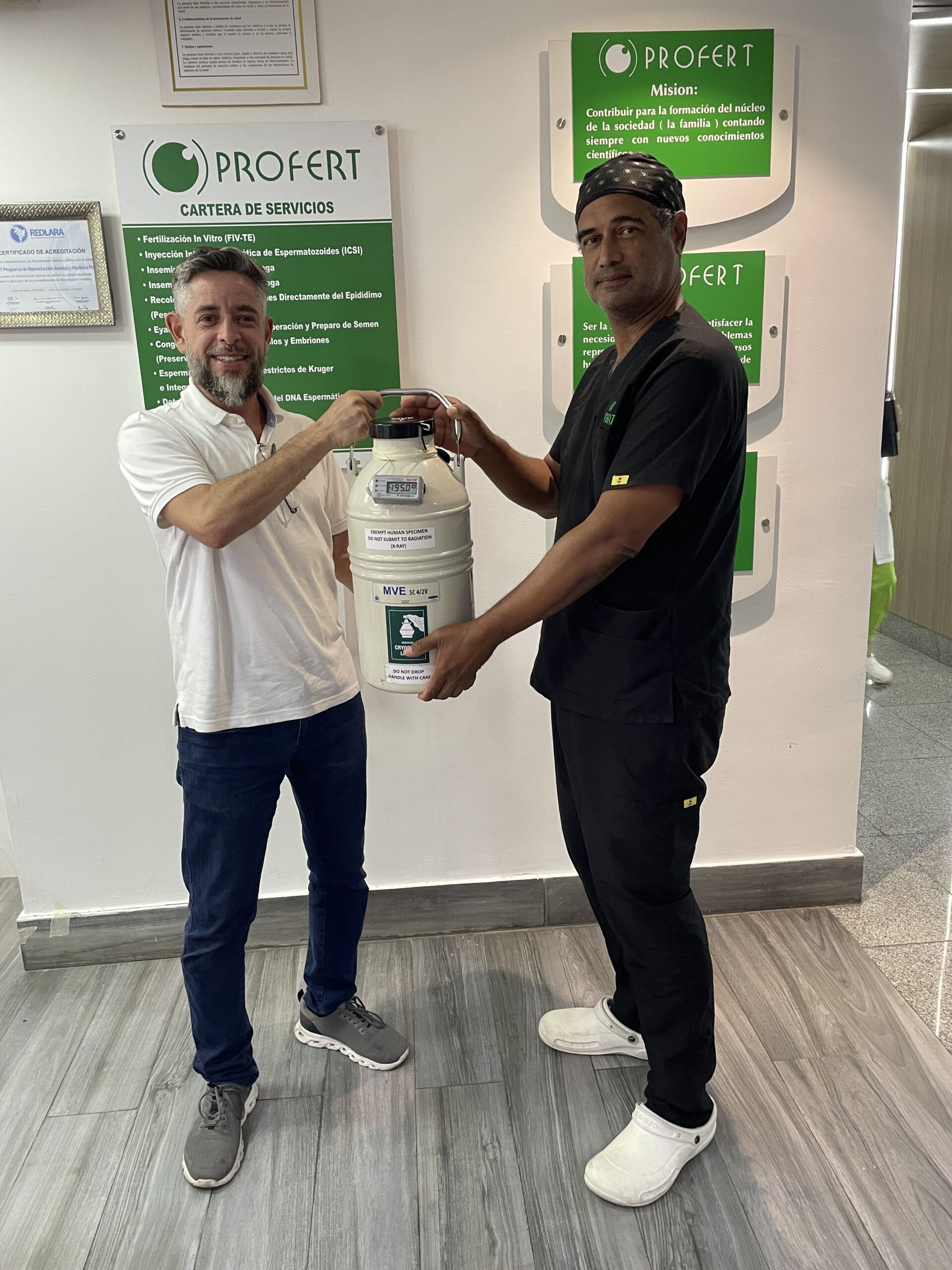 Courier delivering a dewar to a health worker of a fertility clinic.