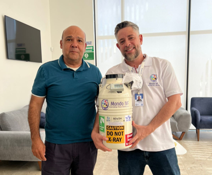 A Mondo IVF courier personally delivering a cryogenic dry shipper to a fertility clinic professional, ensuring continuous chain of custody.