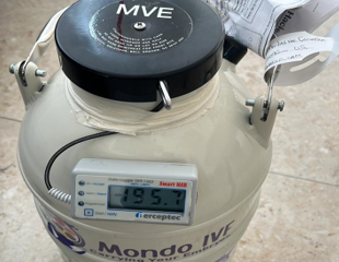 A specialized Mondo IVF cryogenic shipper container equipped with a Perceptec smart USB data logger displaying a temperature of minus 195.7 degrees Celsius.